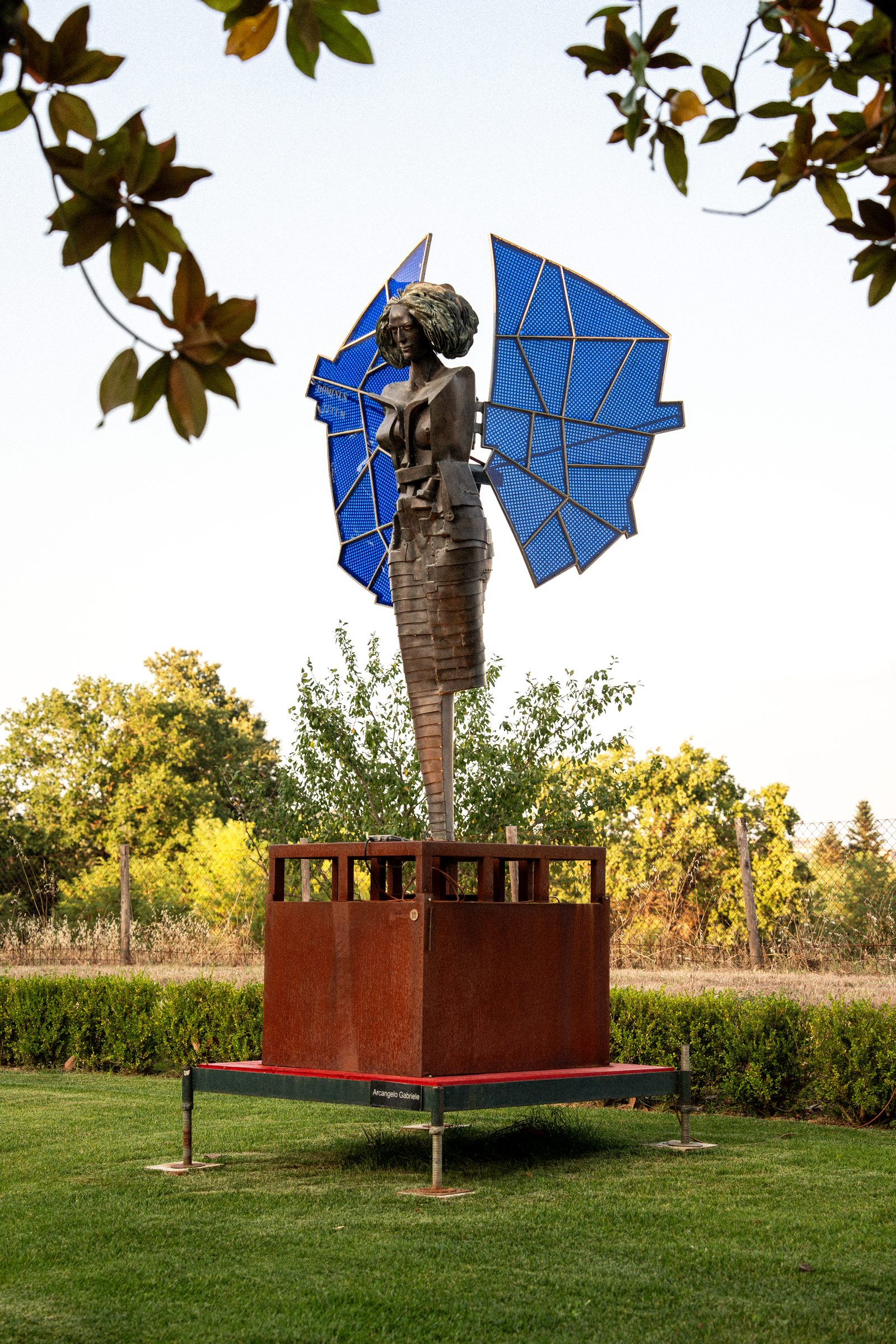 Una scultura di Alberto Inglesi, un arcangelo con le ali blu, sul prato di Volte Alte